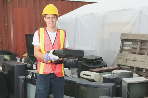 Workers loading a van with rubbish during a mid-size house clearance