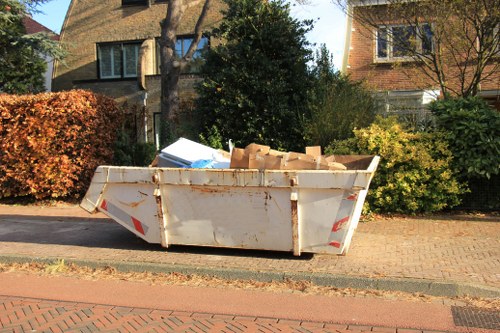 Volunteers loading donated furniture from a Hampstead Heath clearance into a charity van
